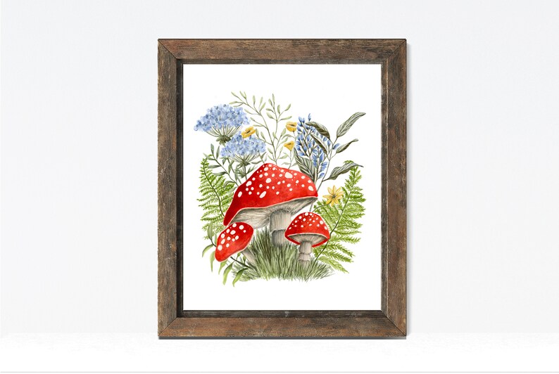 May include: A watercolor painting of red and white mushrooms with white spots, surrounded by green ferns and blue and yellow flowers.