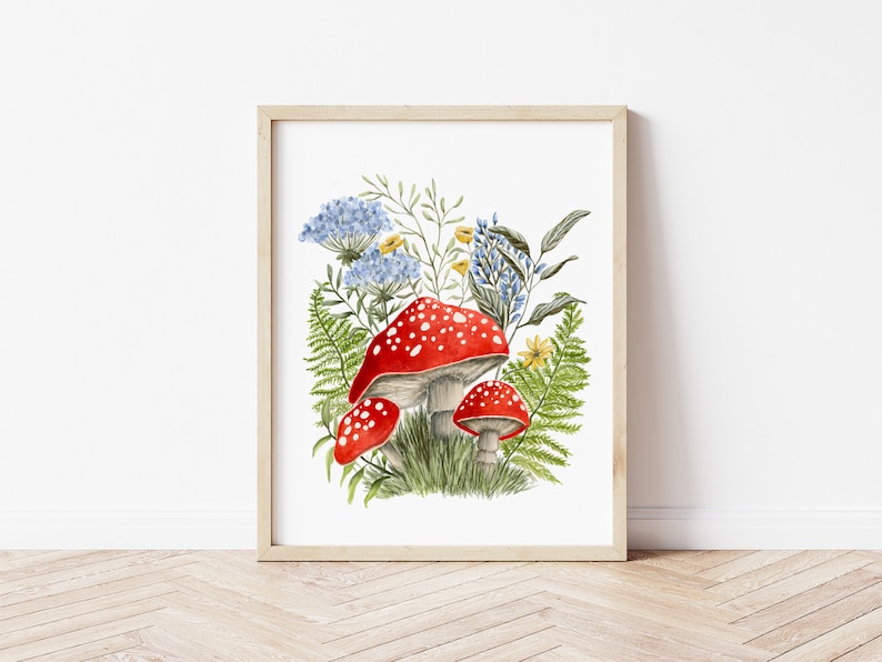 May include: A watercolor painting of red and white mushrooms with white spots growing in a cluster of green ferns and blue and yellow flowers.