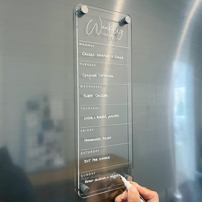 Weekly menu and weekly meal planner inspiration. Premium clear acrylic with white UV ink print and magnet mounts to place your board onto your fridge. Easily write with our erasable chalk markers.