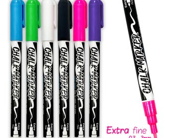 May include: A set of six colorful chalk markers with black barrels and matching colored caps. The markers are labeled "CHALK MARKER" and "Extra fine". One marker is shown separately, with the text "Extra fine 0.7 - 3mm".