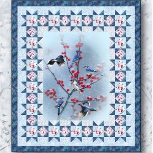 May include: A quilt pattern featuring a winter scene with bluebirds perched on a branch with red berries. The pattern is called "Winter Bluebirds" and is by Hollman Fabrics. The quilt is 58 inches by 68 inches.