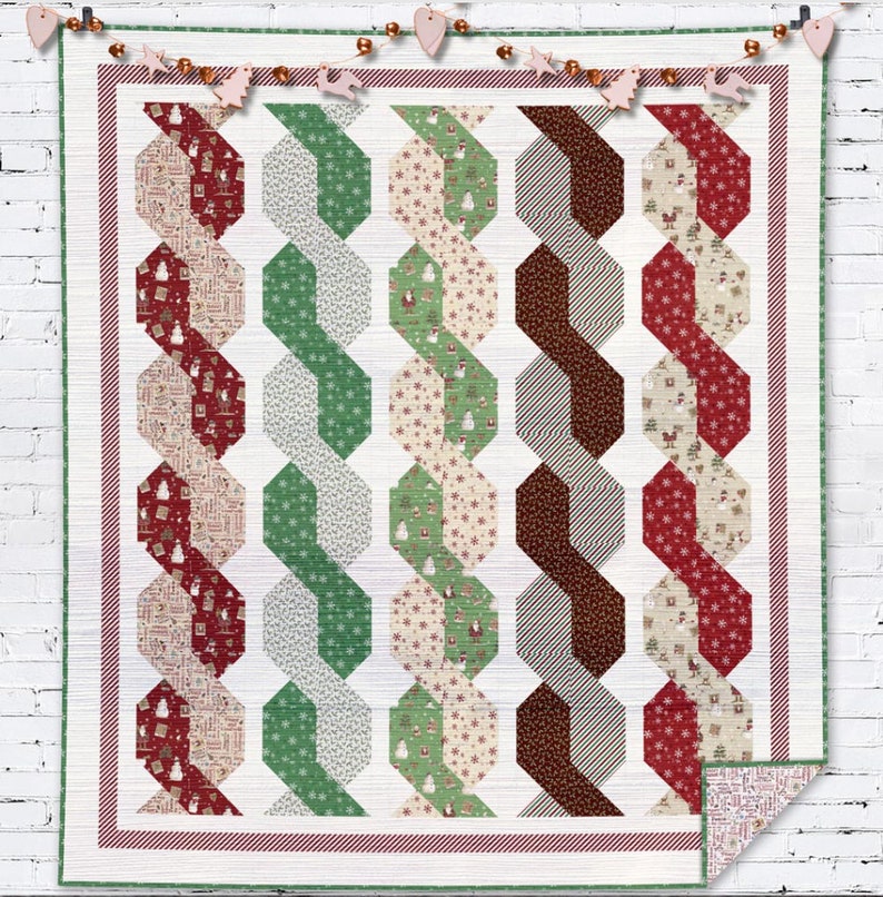May include: A white quilt with a red, green, and brown geometric pattern. The quilt is made up of repeating hexagons and is edged with a red and white striped border.