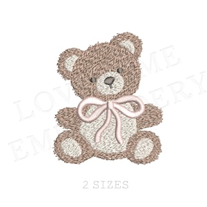 May include: An embroidered teddy bear design in shades of brown and cream, with a pink bow. The bear has a textured appearance, with the text "2 SIZES" below it. This design is suitable for embroidery projects.