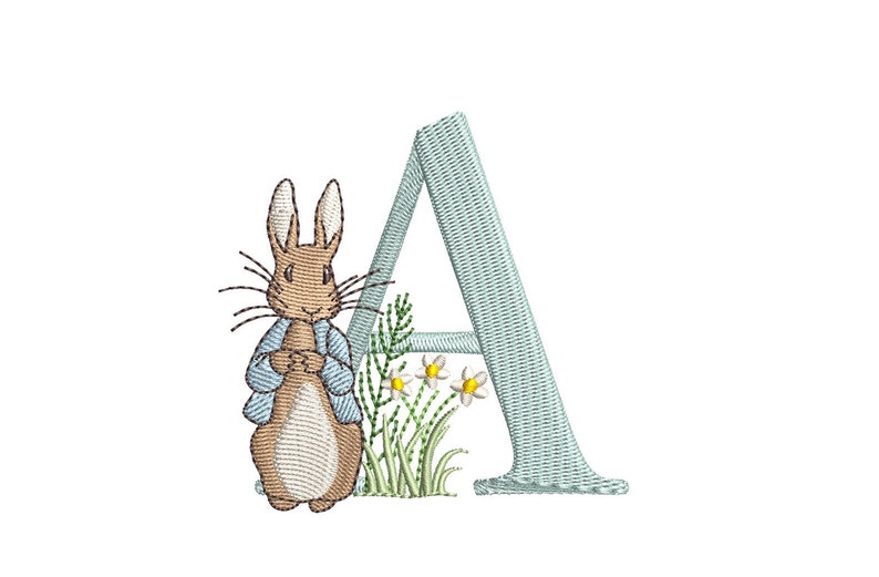 May include: A blue embroidered letter A with a brown rabbit in a blue jacket standing next to it. The rabbit is surrounded by green grass and white flowers.