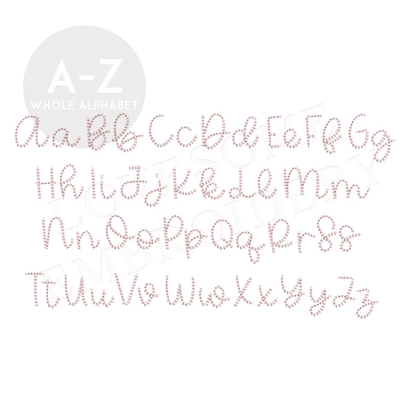 May include: A pink rhinestone alphabet with the letters A-Z in a cursive font.
