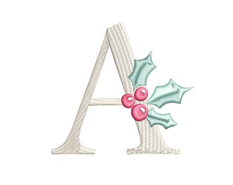 May include: A white embroidered letter A with a green holly sprig and red berries.