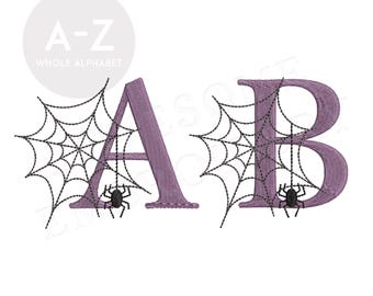May include: Purple letters A and B with black spider webs and black spiders in the center of each letter.