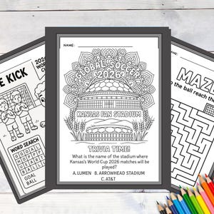 May include: Three black framed activity sheets with soccer themes. One sheet says "FREE KICK" with a soccer field illustration. The center sheet has "GLOBAL SOCCER 2026" and "KANSAS FAN STADIUM" text. The third sheet is a maze.