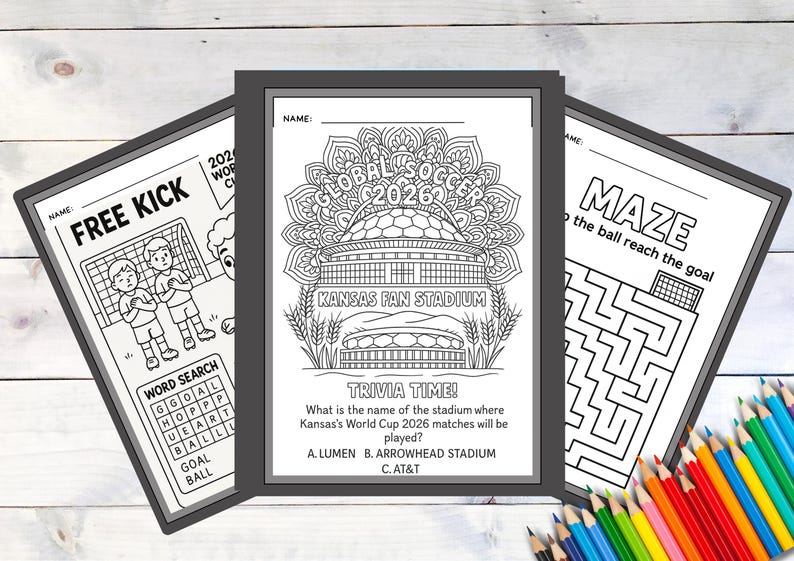 May include: Three black framed activity sheets with soccer themes. One sheet says "FREE KICK" with a soccer field illustration. The center sheet has "GLOBAL SOCCER 2026" and "KANSAS FAN STADIUM" text. The third sheet is a maze.