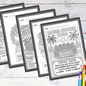 May include: A stack of black and white coloring pages with the text "GLOBAL SOCCER 2026" and trivia questions. The pages feature illustrations of stadiums, soccer balls, and other soccer-related imagery. Colored pencils are in the foreground.