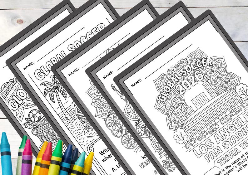 May include: A stack of black and white coloring pages with the text "GLOBAL SOCCER" and "GLOBAL SOCCER 2026". Each page features different soccer-themed illustrations and trivia questions. Crayons in various colors are in the foreground.