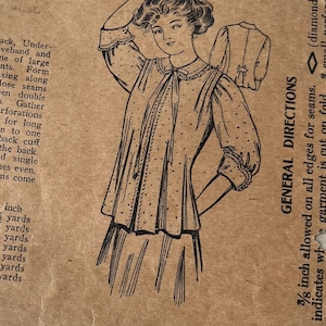 May include: A vintage sewing pattern for a ladies' house jacket. The pattern is printed on a brown card with a black and white illustration of a woman wearing the jacket. The pattern includes instructions for cutting and sewing the jacket, as well as a list of materials needed. The pattern is for size 36 inches and requires 3 yards of fabric.