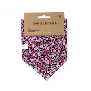 May include: A pink and black floral dog bandana with the text "DOG BANDANA" and "THE ECO DOG DESIGN COMPANY" on a brown tag. The bandana is size "S".