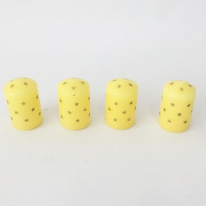 Four vintage 80&#39;s novelty star patterned Christmas candles.