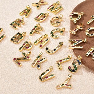 Close-up view of the vibrant multi-color CZ inlays and polished gold finish