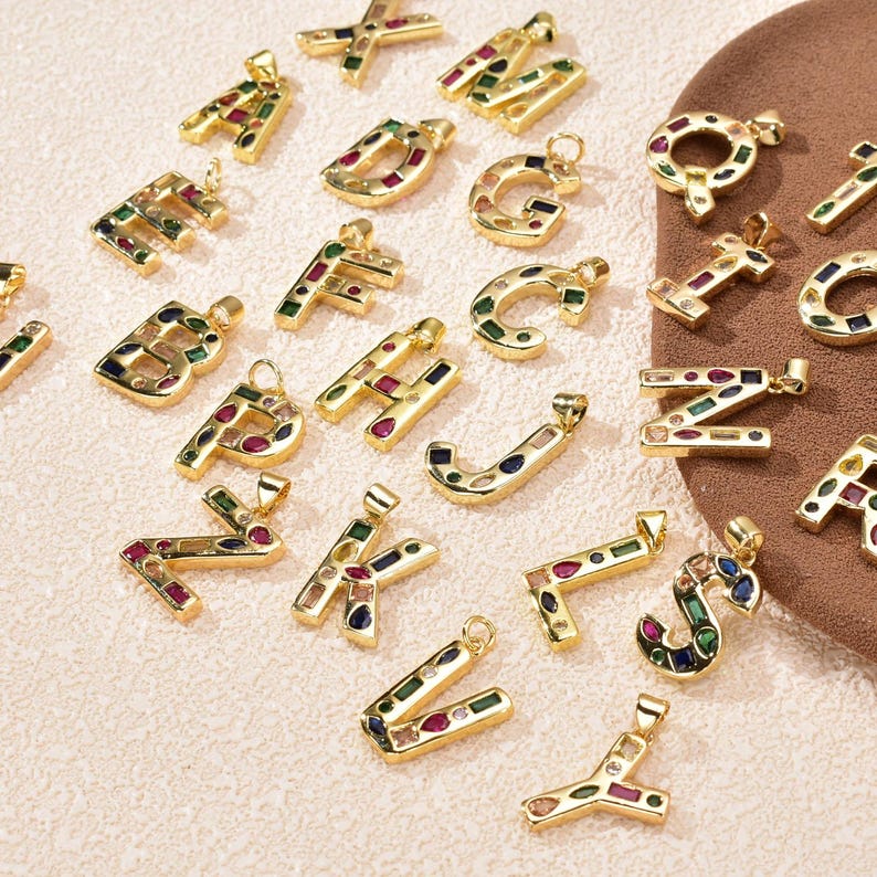Close-up view of the vibrant multi-color CZ inlays and polished gold finish