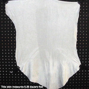 May include: A light gray animal hide, measuring 5.25 square feet, is displayed on a black pegboard.