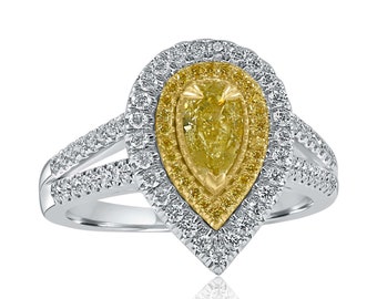 May include: A pear-shaped yellow diamond engagement ring with a halo of smaller diamonds. The ring is set in white gold and has a split shank.