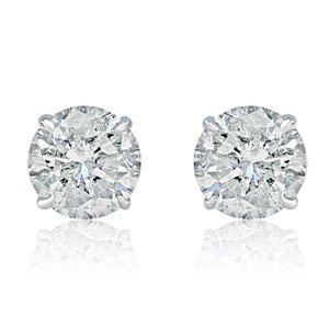 May include: A pair of round diamond stud earrings set in silver.