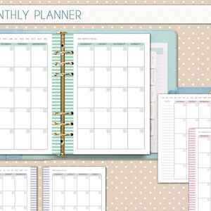 May include: A monthly planner with a green and white striped cover. The planner has a ring binder and includes pages for notes, a monthly calendar, and a weekly calendar.