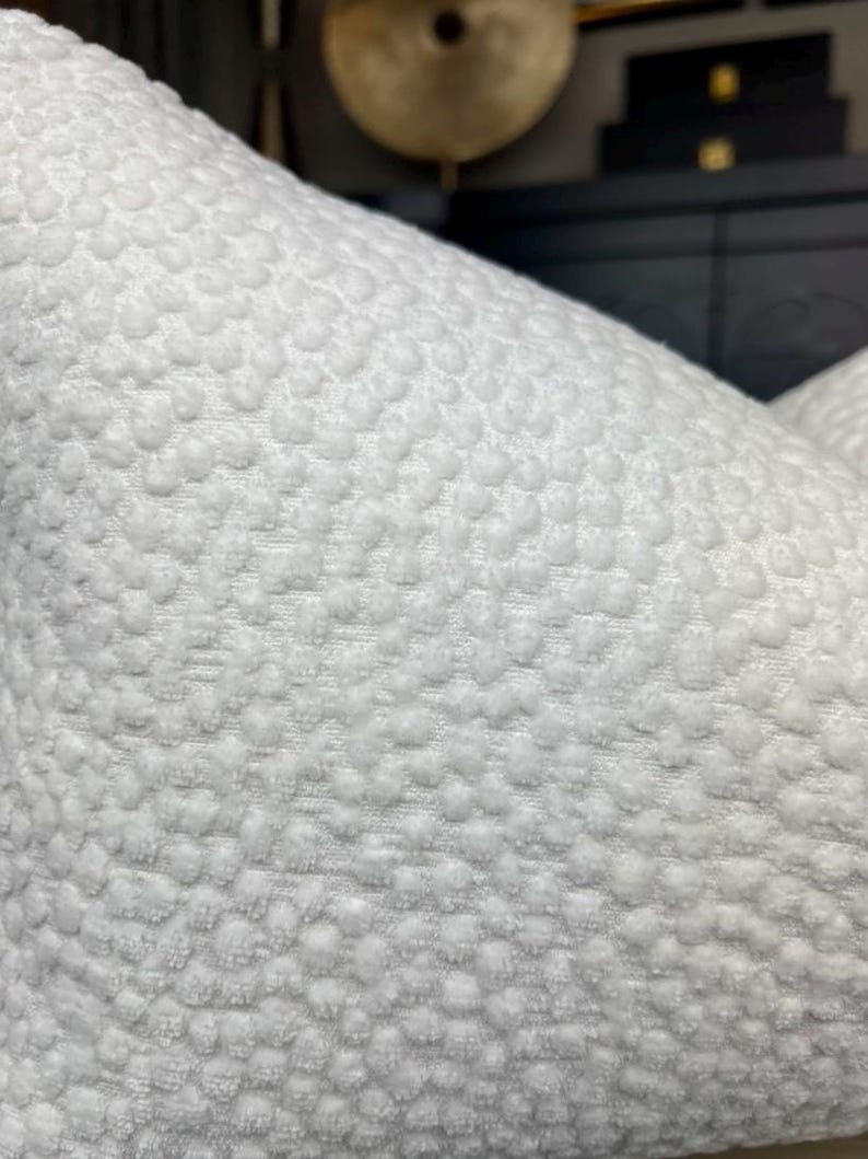 May include: White pillow with a textured, raised dot pattern.