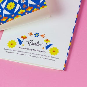 a close up of a business card on a pink surface