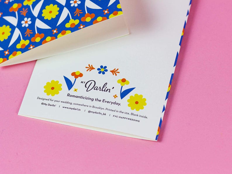 a close up of a business card on a pink surface