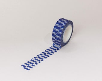May include: A roll of blue and white patterned washi tape. The tape has a geometric design of alternating blue and white squares.