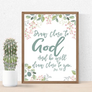 May include: A framed print with a white background and a floral border. The text reads "Draw close to God and he will draw close to you. Jas. 4:8".