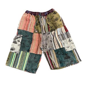 May include: Patchwork shorts with a variety of patterns and colors. The shorts feature a mix of striped, floral, and mushroom designs. The shorts have an elastic waistband and pockets.