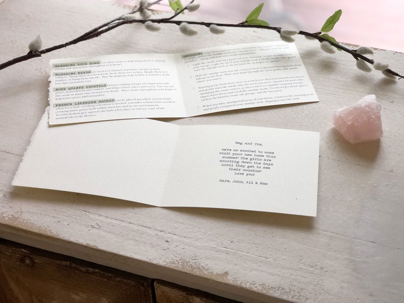 May include: A white card with a handwritten message that reads "Meg and Tim, we are so excited to come visit your new home this summer! The girls are counting down the days until they get to see their cousins! Love you! Sara, John, Ali & Mae."