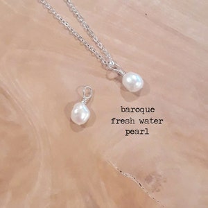 May include: A silver chain necklace with a baroque freshwater pearl pendant. A loose baroque freshwater pearl is also shown. The text "baroque fresh water pearl" is printed in black.