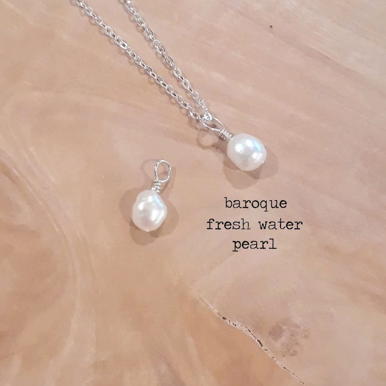 May include: A silver chain necklace with a baroque freshwater pearl pendant. A loose baroque freshwater pearl is also shown. The text "baroque fresh water pearl" is printed in black.
