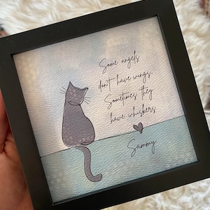May include: A framed art print with a grey cat illustration and the text "Some angels don't have wings. Sometimes they have whiskers." A heart and the name "Sammy" are also included.