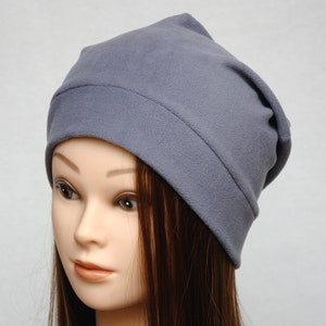 May include: A gray slouchy beanie hat made of soft fleece fabric.