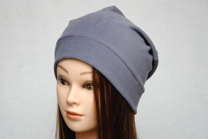 May include: A gray slouchy beanie hat made of soft fleece fabric.