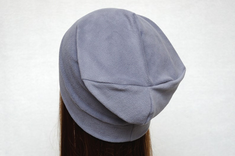May include: A gray slouchy beanie hat made of soft fabric.