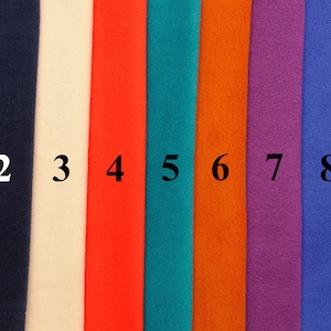 May include: Nine fabric swatches in different colors, numbered 1 through 9. The colors are gray, navy blue, off-white, red, teal, orange, purple, blue, and black.