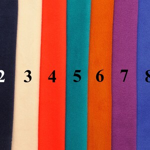 May include: Nine fabric swatches in different colors, numbered 1 through 9. The colors are gray, navy blue, off-white, red, teal, orange, purple, blue, and black.