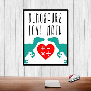 May include: A white printable poster with black text that reads "Dinosaurs Love Math". Two teal dinosaur silhouettes face each other with a red heart in between. The heart has math symbols inside: plus, minus, multiply, and divide.