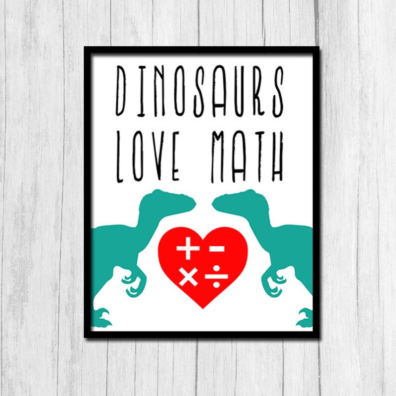 May include: A white printable poster with black text that reads "Dinosaurs Love Math". Two teal dinosaur silhouettes face each other with a red heart in between them. The heart has math symbols inside: plus, minus, multiply, and divide.