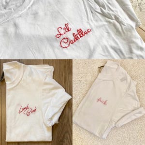 May include: A white ceramic mug with a black handle and the text "But First, Coffee" in a bold, black font. The mug is set against a blurred background, suggesting a cosy setting.