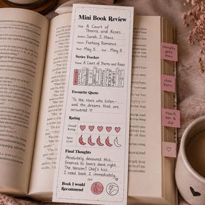May include: A book review card for "A Court of Thorns and Roses" by Sarah J. Maas, with a fantasy romance genre. The card includes a rating system with hearts and chili peppers, and a quote. A lit candle and a book are in the background.