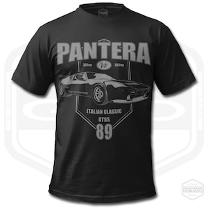 May include: Black t-shirt featuring a gray graphic of a Pantera car with the text "PANTERA" above it. The graphic includes "351cu V8 350hp", "ITALIAN CLASSIC GT5S 89". The shirt has short sleeves and a crew neck.