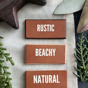 May include: Three rectangular tiles with different edge finishes: Rustic, Beachy, and Natural. The tiles are displayed on a white linen fabric background.