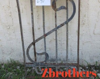 May include: A rusty metal gate with a decorative design. The gate is made of vertical bars with a curved design at the top. The gate is attached to a wall. The number 640 is written on a white tag attached to the gate. The text "Zbrothers furniture" is visible at the bottom of the image.