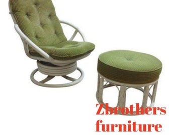 May include: White wicker swivel chair with a green cushion and a matching white wicker ottoman with a green cushion. The chair and ottoman are both in a living room setting.