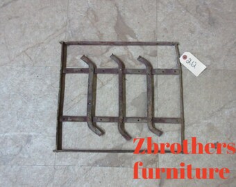 May include: A rusty metal frame with four metal bars attached to it. The frame is rectangular and has a label with the number "212" on it. The text "Zbrothers furniture" is visible in the bottom right corner of the image.