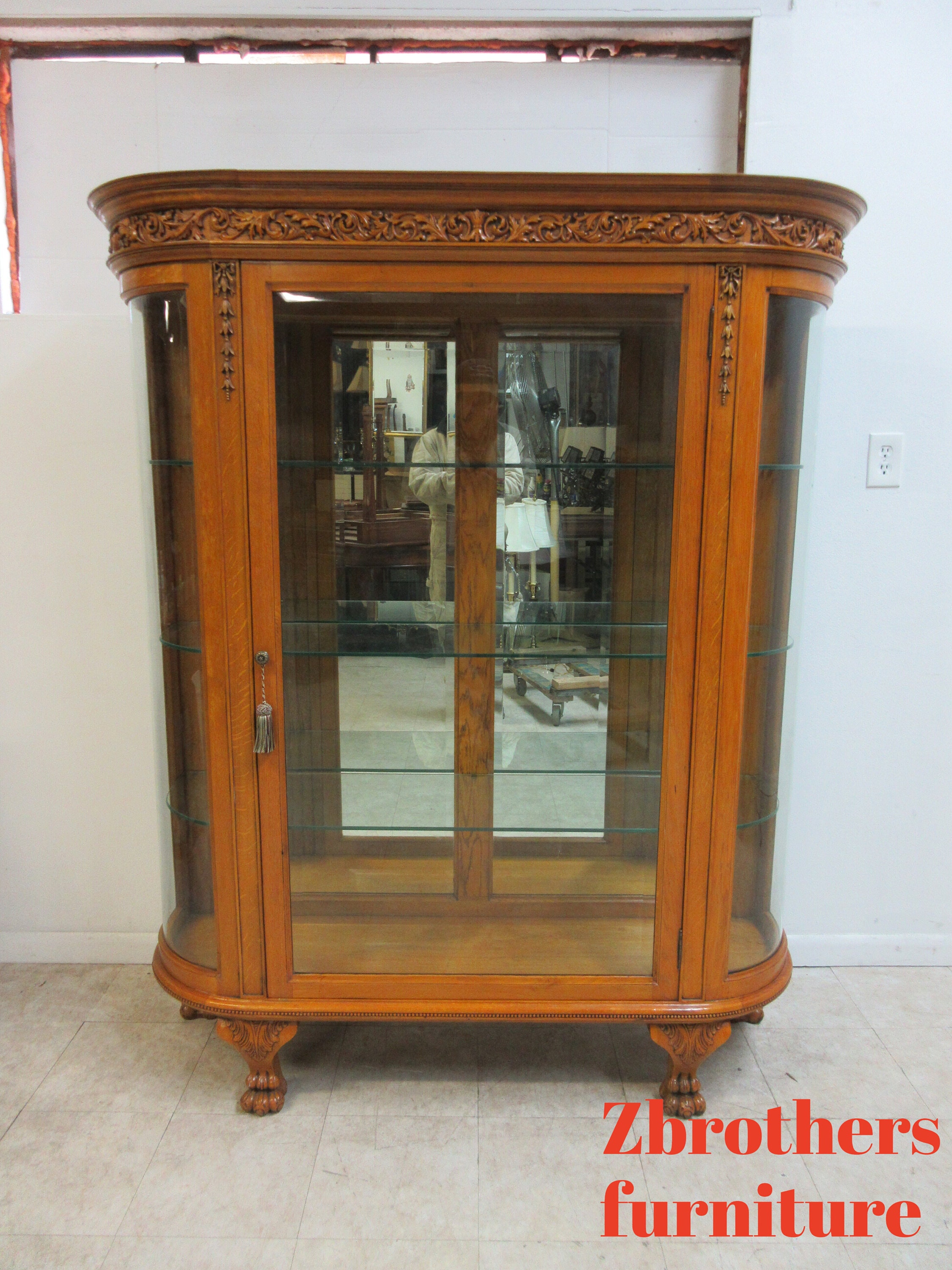 Vintage curio cabinet with curved glass outlet