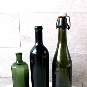 Three antique glass bottles